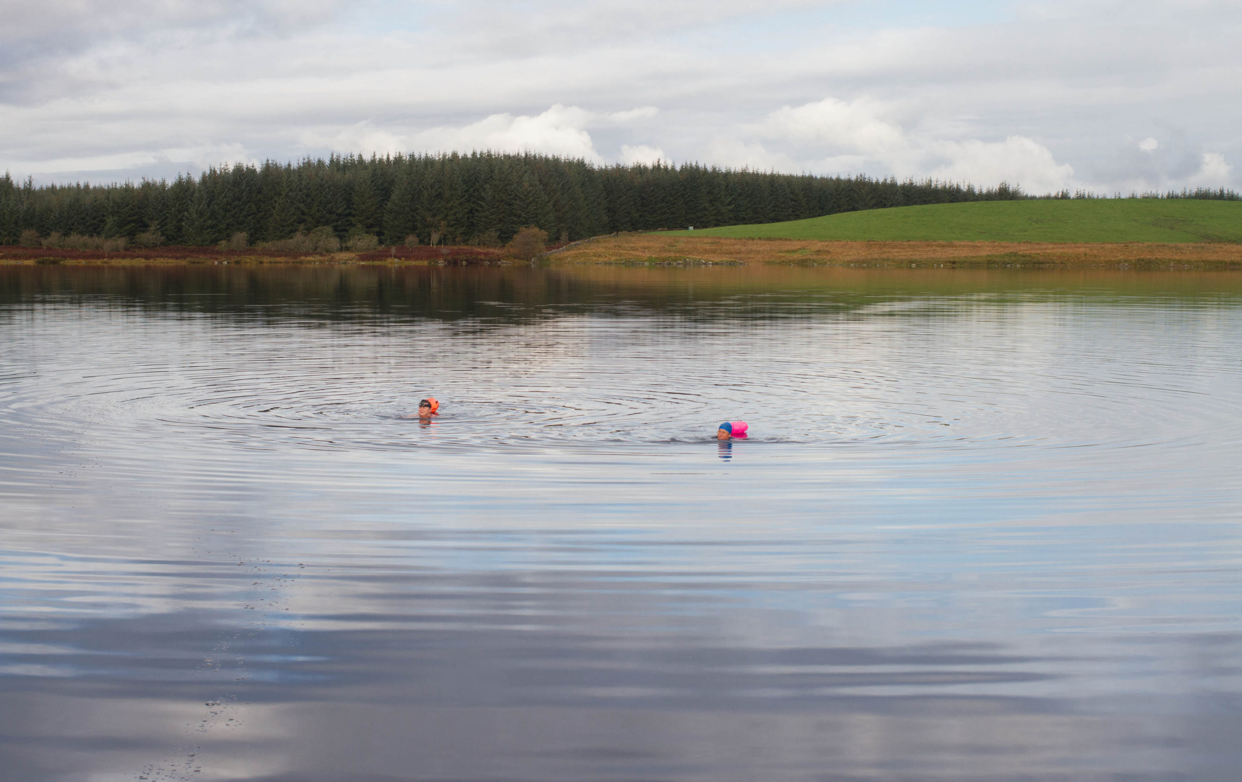 Image of two women wild swimming in Scotland. Wild Swimming retreat at Creeside Escape